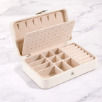 White jewellery box with compartments on a marble surface
